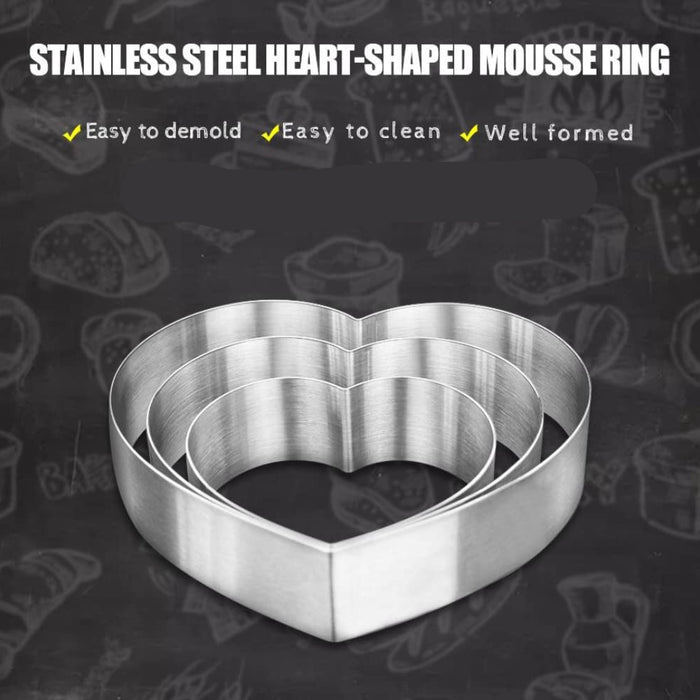  Set of three stainless steel heart-shaped mousse rings in varying sizes, displayed on a dark background with illustrated baked goods and feature highlights including easy to demould, easy to clean, and well-formed design.