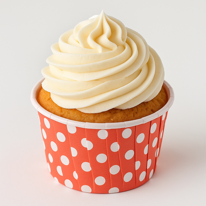 Vanilla cupcake topped with creamy white frosting, presented in a red polka dot paper liner, perfect for parties and celebrations
