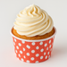 Vanilla cupcake topped with creamy white frosting, presented in a red polka dot paper liner, perfect for parties and celebrations